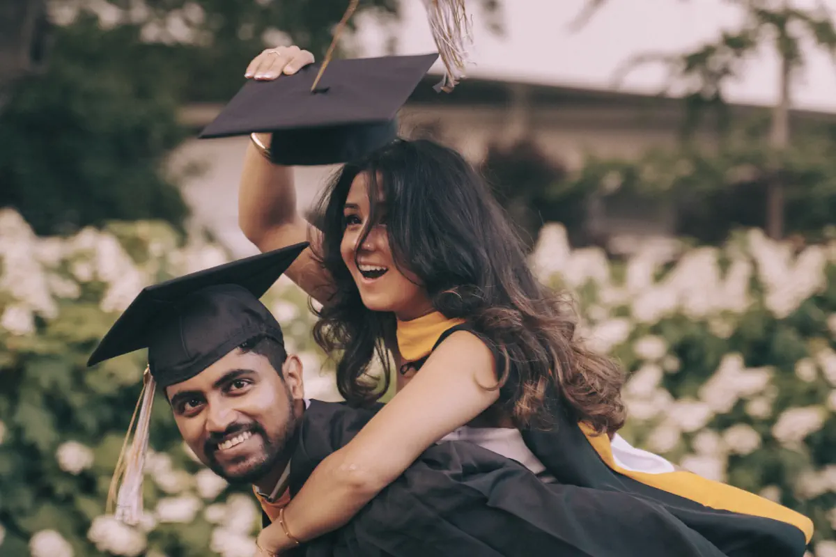 Lata on Naga's back, both in graduation caps and gowns