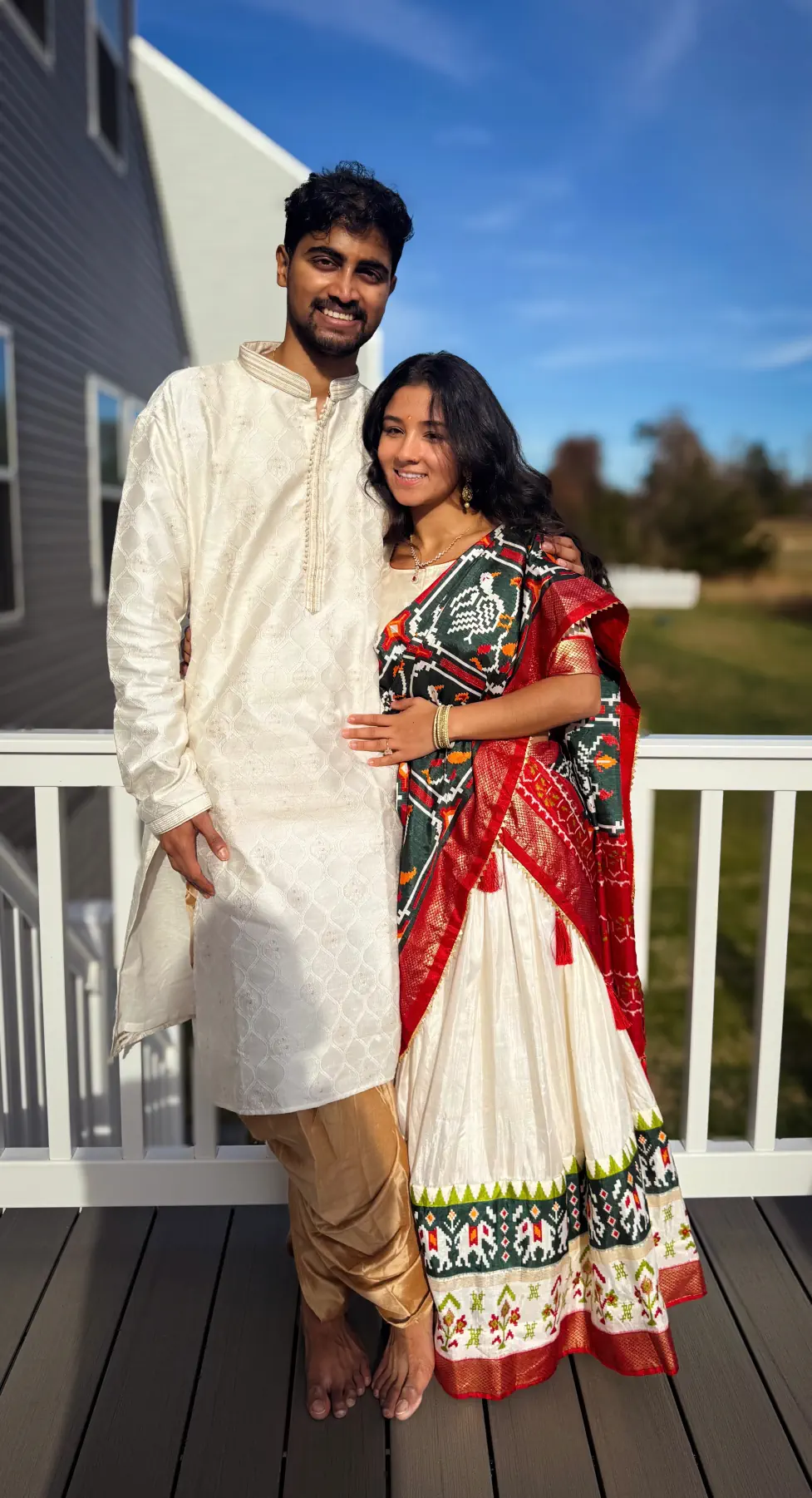 Naga and Lata in Indian formal wear on a sunny porch